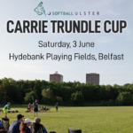A flyer advertising the Carrie Trundle Cup. A daytime photograph of a softball game taken from behind the bench area of one team shows a batter standing at home plate with the catcher to his left. In the foreground, seated spectators watch. The text "Carrie Trundle Cup" "Saturday, 3 June" and "Hydebank Playing Fields, Belfast" is at the top of the image